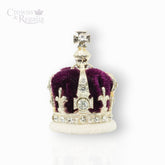 Silver crown with red center and gemstones on a white background, branded 'Crowns & Regalia'.